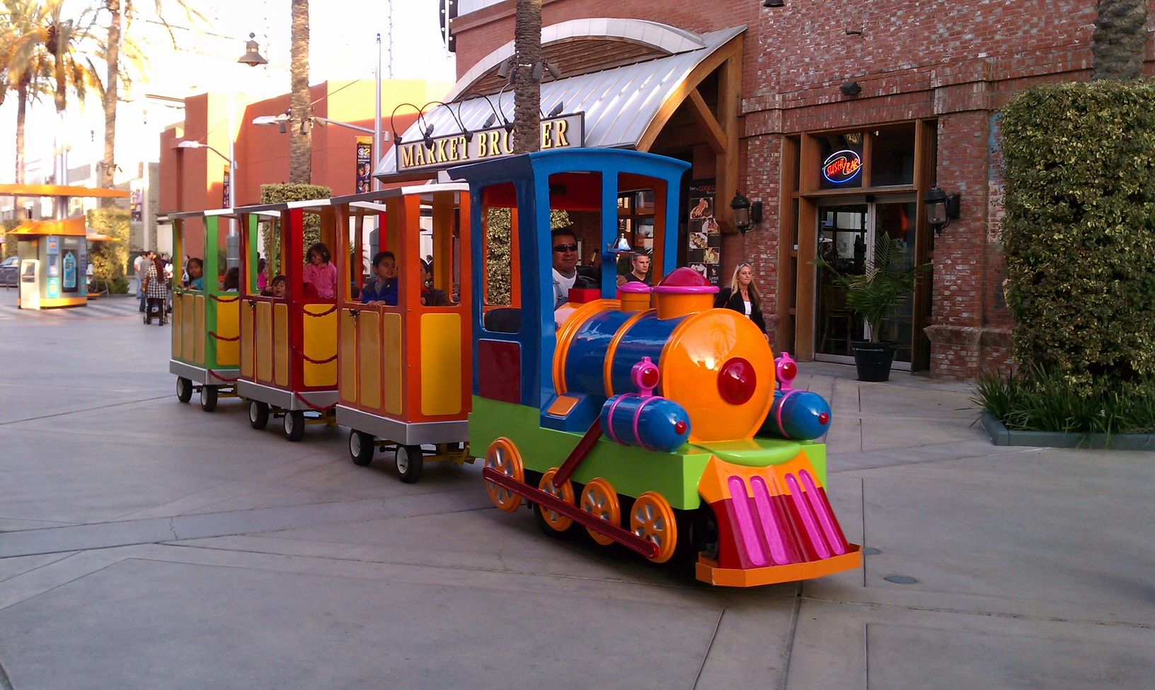 The Mini Express colorful electric trackless train with passenger cars pictured outdoors